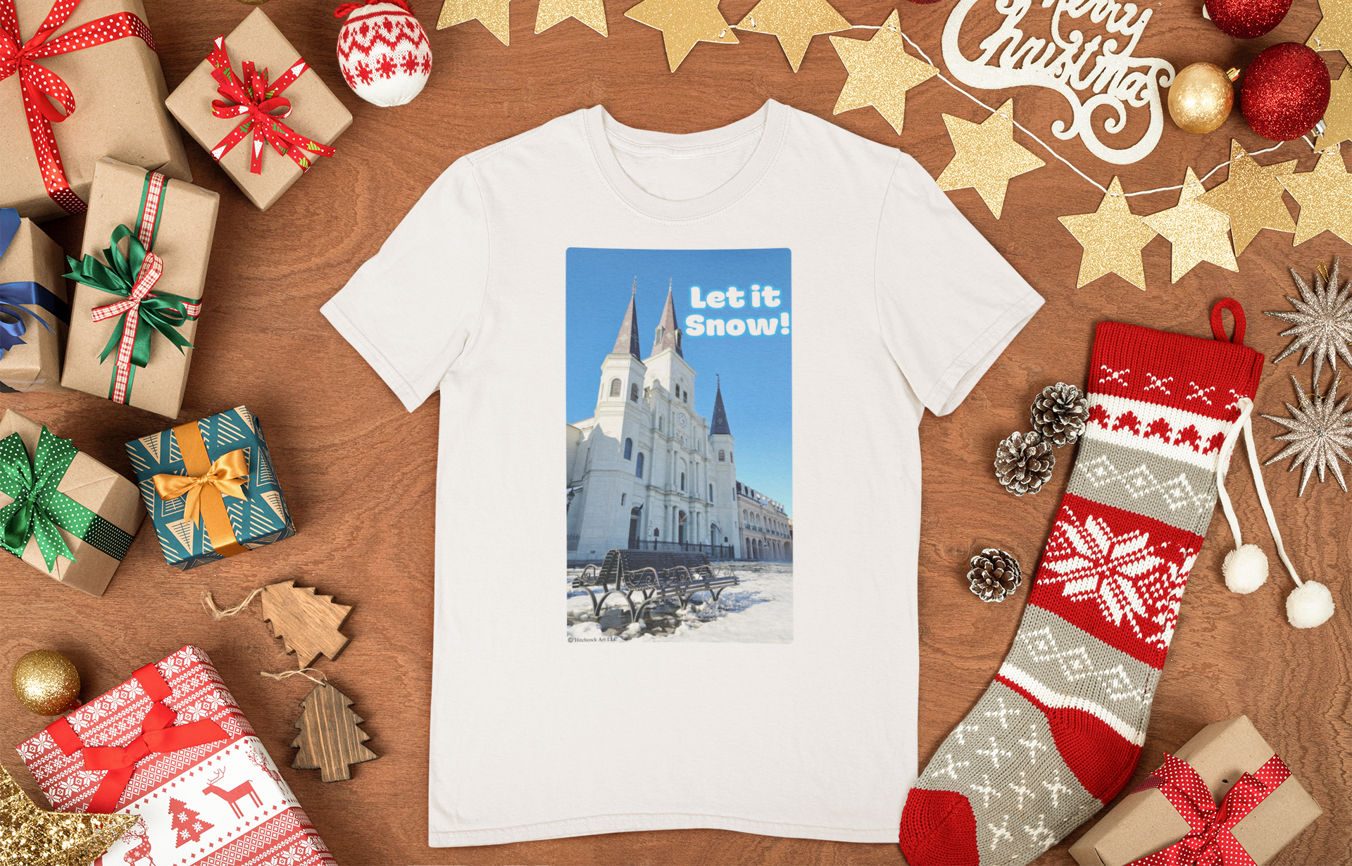 mockup-of-a-flat-laid-tee-surrounded-by-christmas-items-Let-it-snow-hitchcock-art-llc-new-orleans
